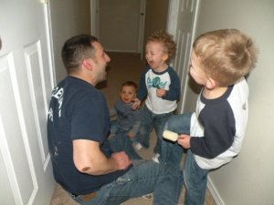 Daddy making kids laugh in hallway